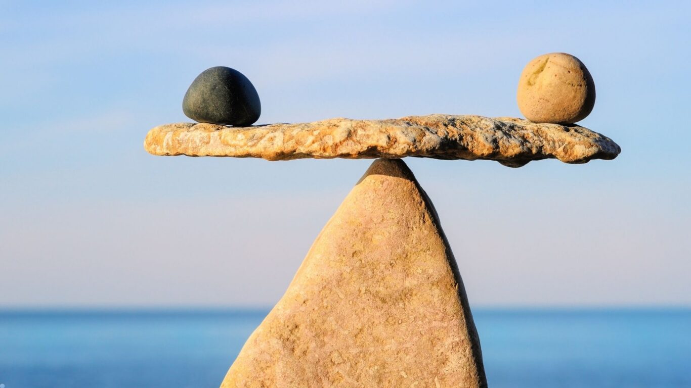 Calm stones balanced against serene sea backdrop, symbolising hotel&rsquo;s peaceful ambiance and relaxation amenities.